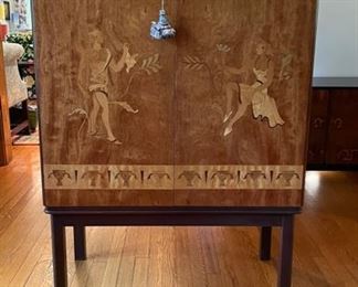 Swedish Art Deco/Neoclassical Inlaid Storage Cabinet by Mjolby Intarsia. Woods include Satinwood, Carpathian Elm, Golden Flame Birch and Mahogany. Interior has adjustable shelves. Measures 48" H x 17" D x 35" W. Photo 1 of 4.