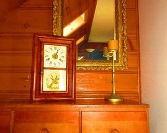 19th century mahogany clock, late 19th century gilded mirror, and a brass candlestick