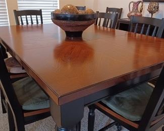 Tall hardwood dining table with 8 chairs. Like new