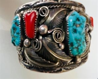 Vintage Signed Navajo cuff style bracelet with hand set natural turquoise and coral stones. Signed. 