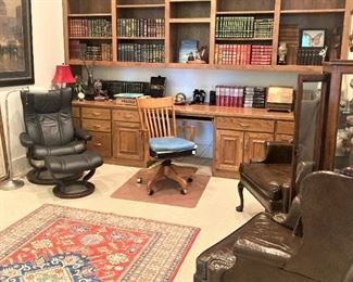 The office is filled with leather bound books.