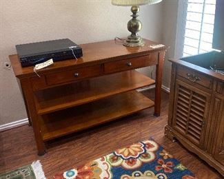 Media stand, colorful rug, DVD player 
