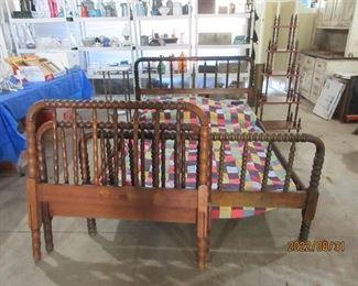 Walnut spindle beds, one full (professionally refinished) and one twin. At headboard, walnut whatnot on right and marble topped Victorian flower stand on left. More quilts for sale in the Garage. Graniteware collection on upper back shelves. White Murano chandelier on left. 