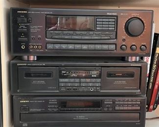 Onkyo sound system: tuner/amp, dual cassette player, 6 disc CD player. 
