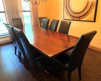 Heavy Solid wood dining room table with leather chairs.