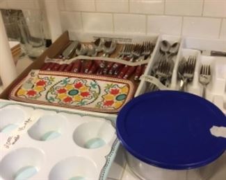Kitchen set of red handled silverware, miscellaneous silverware, Pyrex glass bowl with lid.