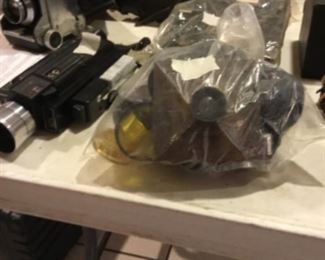 Downstairs- Table full of vintage cameras, binoculars, and movie cameras