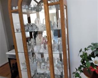 Arch curio cabinet with mirrored back, with a large collection of Precious Moments figurines