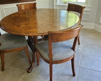 Walnut round kitchen table, set of six dining chairs (four shown). Chairs match the bar stools