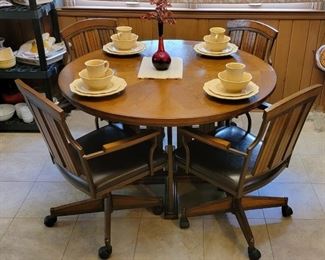 Round dining table with four caster chairs