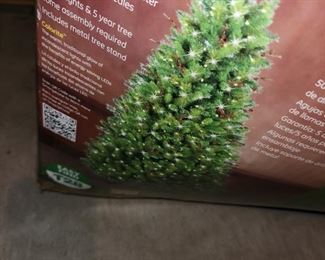 pre-lit 7.5 foot artificial Christmas tree, with lights and pine cone decorations
