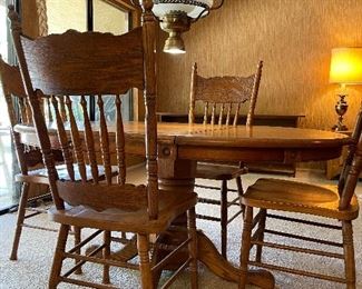 Oak table with leaf and 4 chairs. 