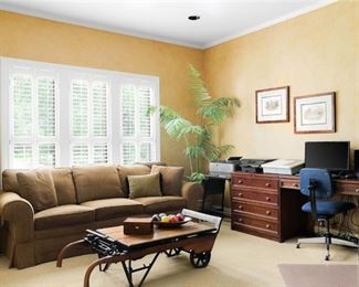 Sligh "Homeworks" L-shaped corner desk (only partially shown), Clayton-Marcus 7 foot tweed brown upholstered sofa, , the coffee table is an antique mercantile cart & grain scale of solid wood and cast iron, vtg ficus in handcrafted planter, vintage brass lamps, pair of Drexel end tables 