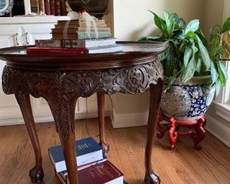 Carved center table with 30" diameter burled wood top and ball & claw feet 