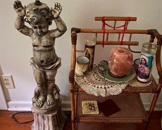 Na-na-na-na-na statue with rad rattan shelf. Also featured are just a couple of more religious candles for your viewing pleasure.