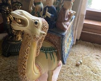 This camel is really freaking out about all of these dudes on his back.