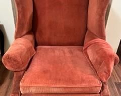 Orange, well worn and comfy armchair