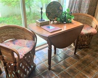 Two of four rattan curved back chairs; dropleaf table