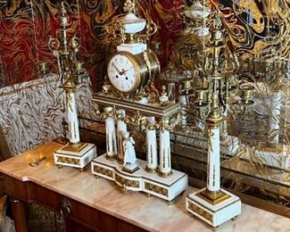 French Antique three piece marble, and gold mantle clock and candlesticks Medaille D’ Argent Crystal	Clock measurements: 27.5 inches, tall, 14.5 inches wide, 4.5 inches deep. Candlestick measurements: 26” x 10” x 10”.	
