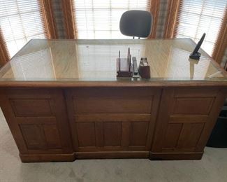 Remington Oak Office Desk (1920's)                                               60"w 32"d 30"t    Venere on top of desk came off can be sanded and stained. Glass top broke on one corner. Still a Great piece!        $300.00