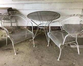 Two metal chairs and table