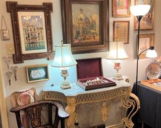 Iron and marble console; original oils and watercolors