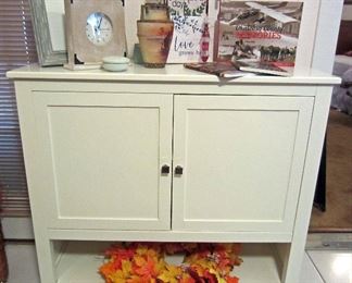 White two door cabinet, Nippon vase, historical books