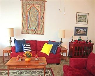 Living room:  matching sofa and love seat, tables, tapestry 