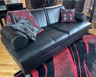 Black leather convertable sofa - Very versatile! Arms and back cushions lift out  - can be used as a guest bed or bench seating once arms are removed.  81"W x 35"D x 32"H,  $399