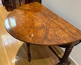 Another view shown as a demi-lune style table with only one drop leaf up.