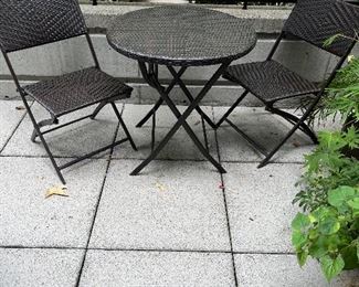 $60. Folding bistro set outdoor wicker.   Two chairs and a table that measures 27" diameter x 28"h.