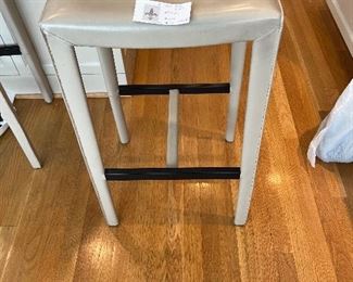 $220. Set of 3 30" stools, off-white leather from Crate & Barrel.