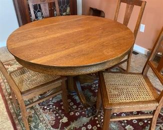109m Oak Claw Foot Table And Four Chairs With Cane Seats