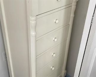 White chest of drawers and digital alarm clock