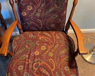 Vintage or antique rocking chair with burgundy paisley fabric cushions
