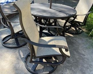 TROPITONE Banchetto Slat Aluminum Table with TROPITONE Montreux High Back Swivel Rocker Scroll Arm Chairs
