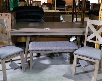 Ashley Furniture with 4 chairs and a bench.