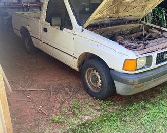 1990 Farm Truck with camper shell (seen hanging on the wall in another picture).  
