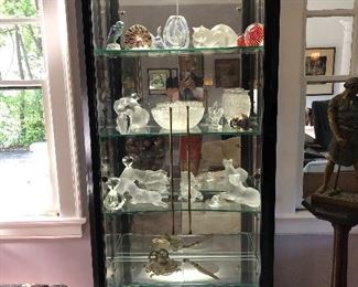Lighted glass shelf display cabinet filled with Lalique 