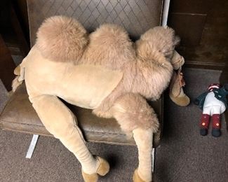 Other of the pair of Barcelona chairs with vinyl cushions and a huge stuffed  camel