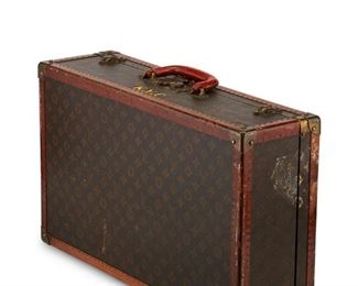 3003
Louis Vuitton
1821-1892, French
A Vintage Small Breveté Suitcase Trunk, Circa 1926-1954
Interior embossed paper label (damaged): Paris 70 Champs-Élysées / 149 New Bond St. London / Nice / Cannes / Vichy [addresses illegible] / 79139; brass lock hardware stamped: Louis Vuitton / Made in France; brass latches stamped: LV
The suitcase with VL Monogram canvas-wrapped exterior with VL-stamped nailed leather edging, brass hardware, a leather handle, and with the interior in starched cotton, with twill tape ties woven with Louis Vuitton name, and buckles marked: Louis Vuitton / Breveté; personalized with yellow painted monogram: K.Y.C.
6.875" H x 23.75" W x 14.5" D
Estimate: $1,200 - $1,800