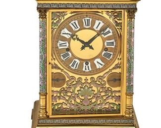 3001
A French Polished Brass And Champlevé Mantel Clock
Fourth-Quarter 19th Century
Three-train, five-gong movement with a stepped outset polished brass top over a serpentine-outline green and pink champleve-enameled scrolling foliate frieze, raised on similarly enameled Corinthian columns before a glazed rectangular case housing the circular gold-toned face with applied white enameled cartouches containing black Roman numeral hour markers, with subsidiary dials for Chime/Silent and Gong/Stop within an enameled scrolling foliate surround, raised on a stepped rectangular plinth, on bracket feet
18" H x 12.5" W x 10" D
Estimate: $4,000 - $6,000