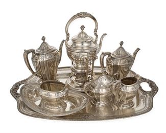 3002
A Towle "D'Orleans" Sterling Silver Tea And Coffee Service
Circa 1923
Each marked for Towle sterling and variously numbered
Designed 1923 by Harold E. Nock, comprising a hot water kettle with burner (14"), a coffee pot (10"), a teapot (9.25"), a covered sugar bowl (6.5"), a creamer (5.5"), a waste bowl (4"), an oval dish (2.25" H x 12.375" W x 7.125" D), and a large serving tray (1.5" H x 26.5" W x 17" D), 8 pieces
269.28 gross oz. troy approximately
Estimate: $5,000 - $7,000