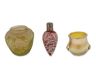 3008
A Group Of Art Glass Cabinet Items
First-Quarter 20th Century
Comprising a signed Galle cabinet vase in pink/green cameo glass (2.5" H x 2.5" Dia.), a Louis Comfort Tiffany signed and numbered LCT favrile toothpick holder with loop handles (2" H x 2.25" W), and an English Webb rose/white cameo glass scent vial in a tropical leaf design, with a silver hinged top (4.25" H x 1.75" W), 3 pieces
Estimate: $600 - $800