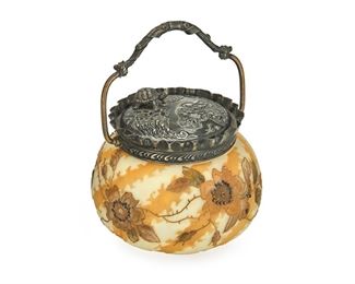 3009
A Mount Washington Crown Milano Art Glass Biscuit Barrel
Late 19th/Early 20th Century
With impressed "MW" mark to lid, numbered 4416
Model no. 3911, the matte glass jar with gold enamel roses set with metal jewels against alternating bands of cream and white "turtle track" designs, fitted with a silver-plated ruffle rim, handle, and lid with repousse flowers and haute-relief turtle
6.5" H x 5" Dia.
Estimate: $300 - $500