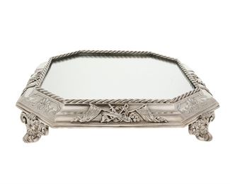 3013
An English Silver-Plated Plateau Tray
First-Quarter 20th Century
With illegible marks and numbers to underside
The octagonal, footed tray with decorated with crossed flags, telescopes, and swords encircled by a wreath and rope border surrounding a mirrored top and raised on figural mask feet
3.5" H x 17.5" W x 17.5" D
Estimate: $600 - $800