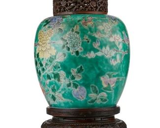 3023
A Chinese Porcelain Ginger Jar
Late 19th/Early 20th Century
The porcelain jar with polychrome enamel flowering branches and birds raised on a carved wood stand and with topped by a nephrite-set carved wood lid
12.5" H x 7" Dia.
Estimate: $500 - $700