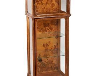 3033
Emile Gallé
1846-1904, French
A Vitrine Cabinet, Circa 1885-1904; Nancy, France
Inlaid signature: Gallé
The vitrine with stylize rectangular top over a single glazed-door cabinet top and lower glazed-door cabinet bottom with adjustable shelves, with two marquetry inlaid rear panels with oak leaves, acorns, and a bird
61.25" H x 28.5" W x 17.75" D
Estimate: $7,000 - $9,000