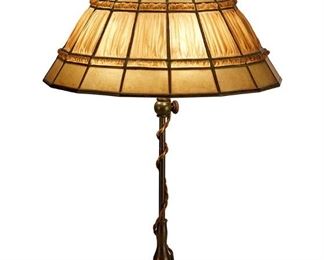 3035
Tiffany Studios
A "Linenfold" Table Lamp, First-Quarter 20th Century; New York, NY
Shade signed: Tiffany Studio New York 1924 PAT APPL'D FOR; base signed: Tiffany Studios / New York / [T.G.D.Co. monogram] / D 804
The amber "Linenfold" glass shade, also called "Favrilefabrique," on a three-light patinated bronze base with gadrooned foot, electrified
Overall: 22" H x 14.5" Dia.
Estimate: $8,000 - $12,000