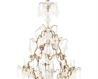 3081
A Bronze And Crystal Chandelier
20th/21st Century
The twenty-light chandelier with a tiered bronze frame with scrolled arms and cut crystal prisms, rosettes, and pendalogues with impressed angel masks, crucifixes, and "IHS," electrified
68" H x 37" Dia.
Estimate: $2,000 - $3,000